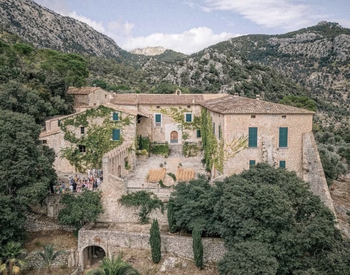 The stone buildings and green shutters of Finca Comassema surrounded by Mallorca’s mountains